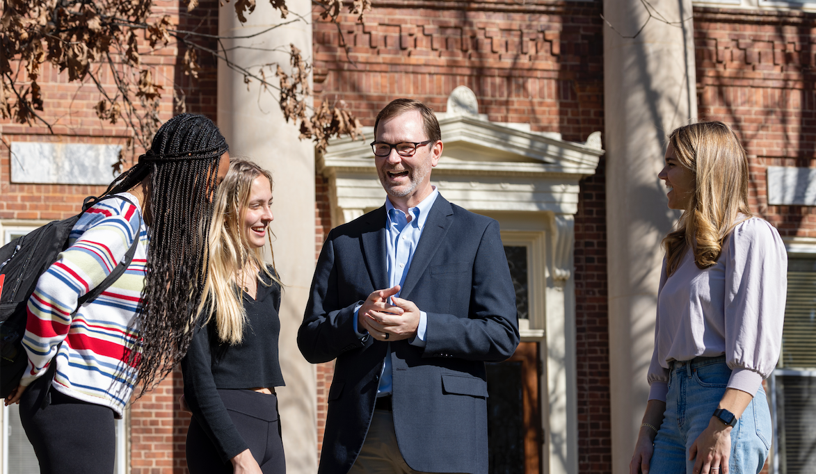 Professor and Department Head J. Derrick Lemons engaging with students after class.