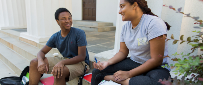 Students talking on the steps of a building at UGA